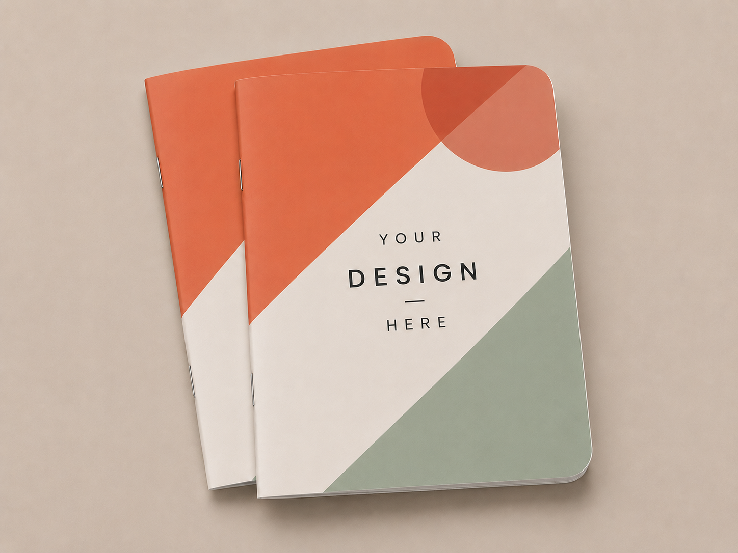 Staple-bound notebook with a custom printed cover resting on a plain surface